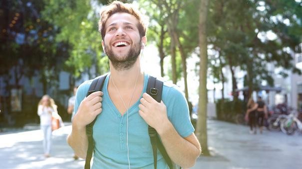 happy-college-student-walking-Dollarphotoclub_68953102