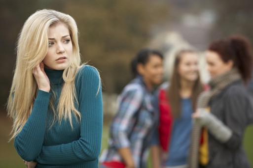 2196543-upset-teenage-girl-with-friends-gossiping-in-background