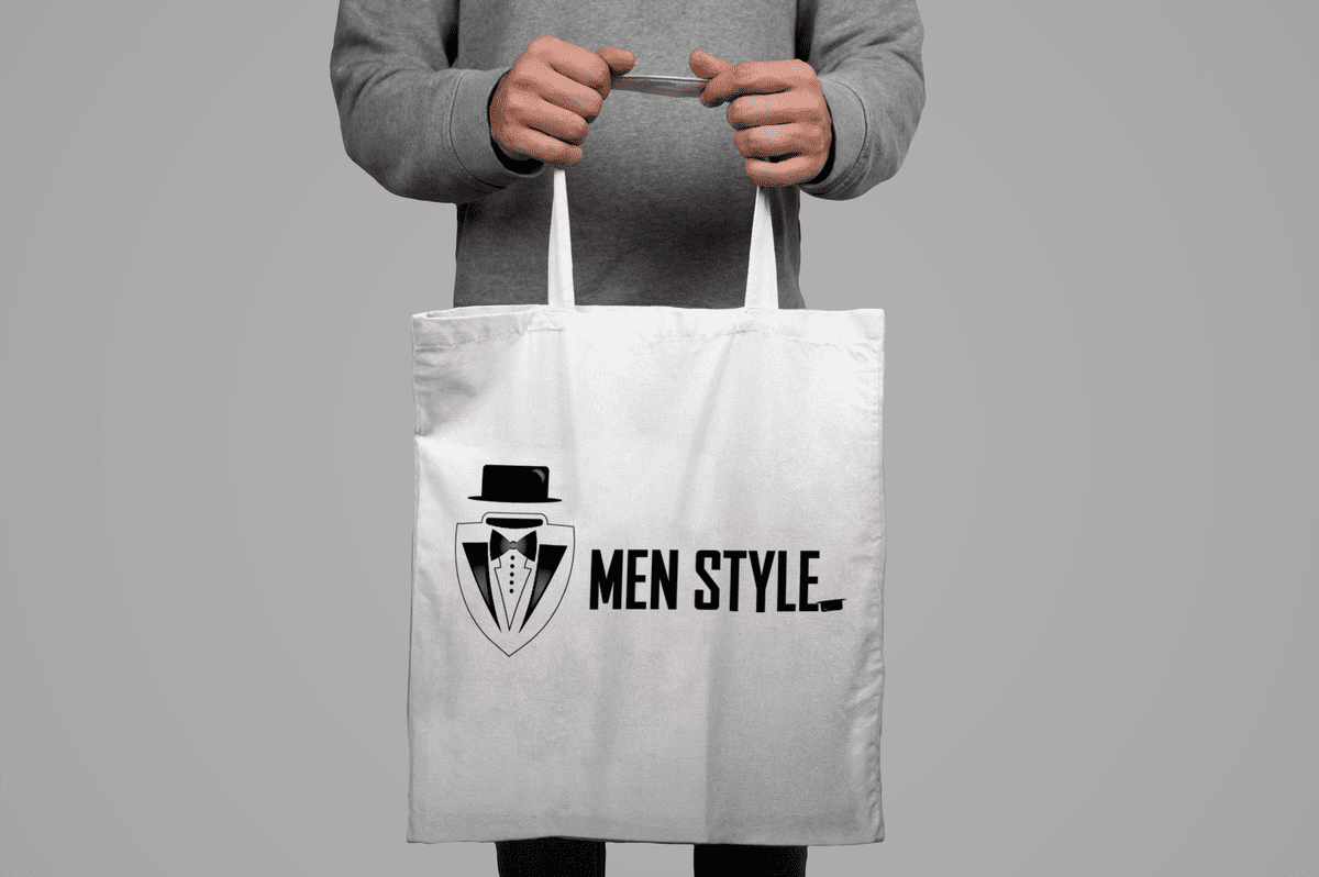 Mockup_of_model_holding_a_tote_bag_on_a_gray_background